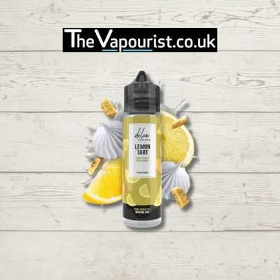 Dolce Lemon Tart E-Liquid 50ml bottle with lemon slices, meringue, and pastry on wood background. Rich citrus vape in 70/30 VG/PG blend.