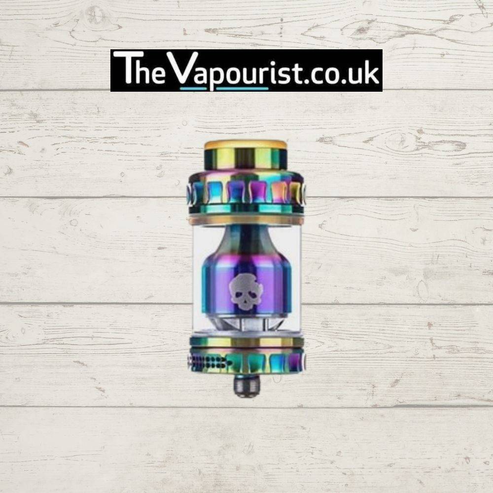 Dovpo Blotto RTA in rainbow finish, a rebuildable tank atomiser for single and dual coil builds, displayed on wood background with TheVapourist.co.uk logo.