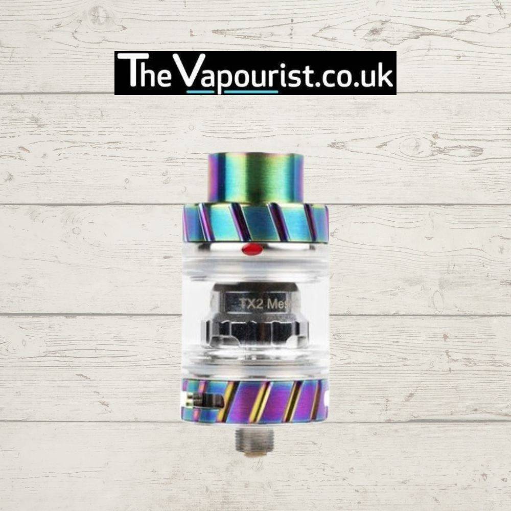 Freemax Fireluke 2 Tank in rainbow finish with TX2 mesh coil, designed for flavour and vapour, shown against a wood background.