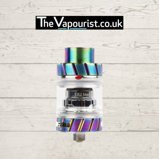 Freemax Fireluke 2 Tank in rainbow finish with TX2 mesh coil, designed for flavour and vapour, shown against a wood background.