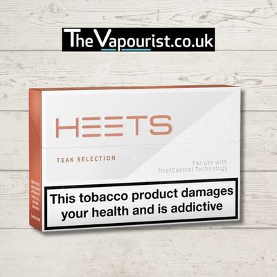 IQOS Heets Teak Selection pack with health warning label displayed.