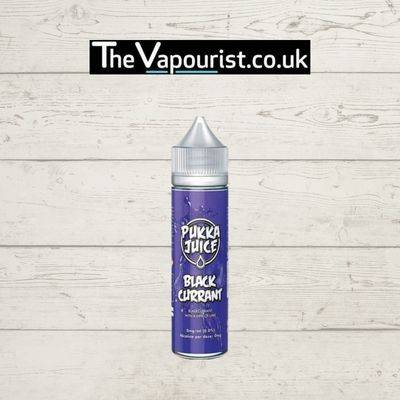 Pukka Juice Blackcurrant 50ml vape liquid with bold blackcurrant flavour, displayed in a purple bottle against a wooden background.