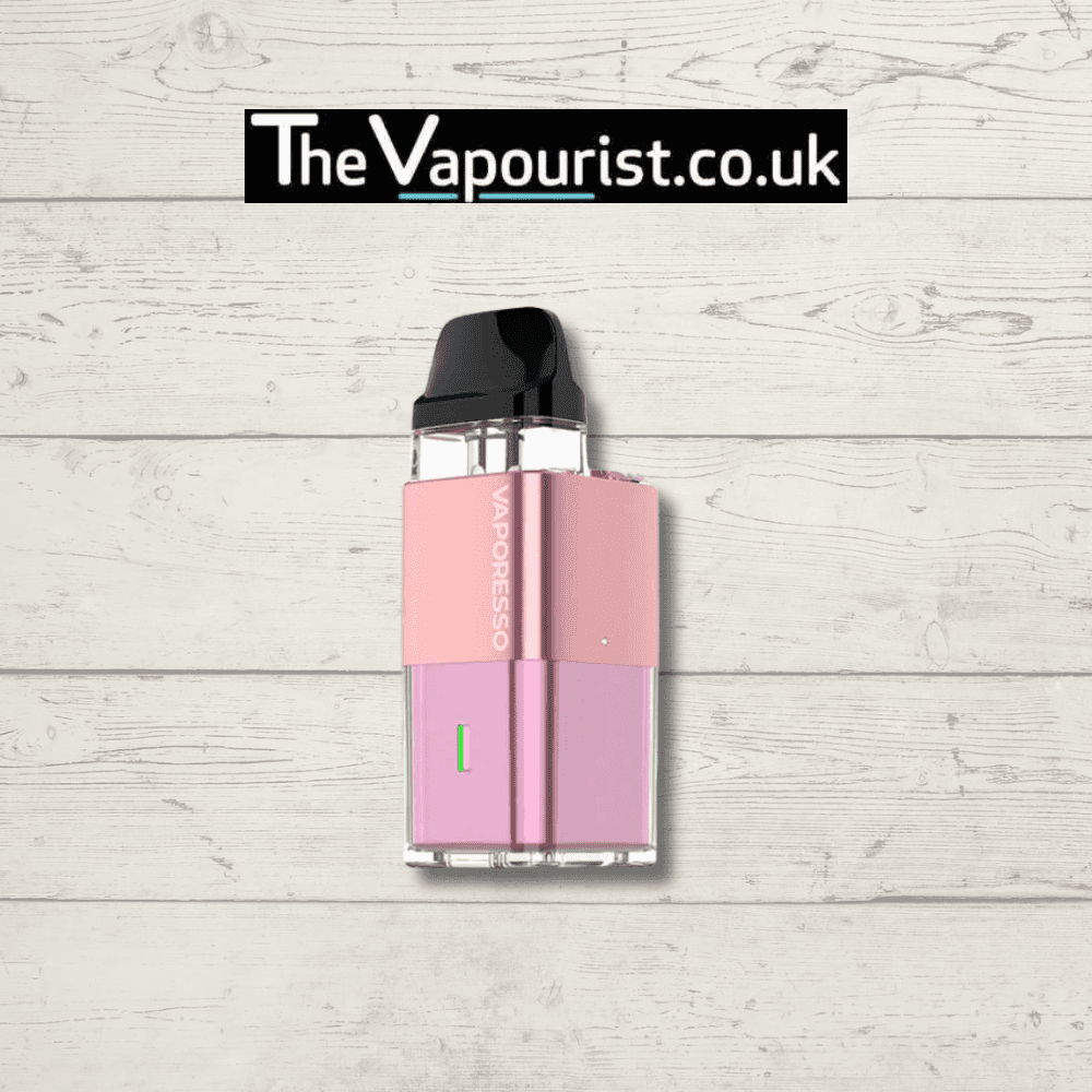 Pink Vaporesso XROS Cube Pod Kit with compact design and Corex heating, featured on rustic wood backdrop for TheVapourist.co.uk.